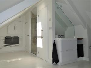 a bathroom with white cabinets and a sink at Private Double Room and Ensuite in Historic Cornish Cottage in Helston +21 photos