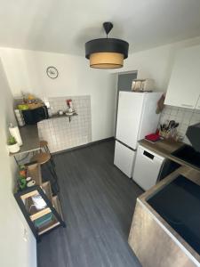 uma pequena cozinha com um frigorífico branco em Appartement Centrale Confort em Montalieu-Vercieu