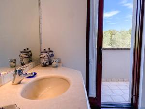 a bathroom with a sink and a window at Casa Sterlizia [Olbia] in Olbia +27 photos