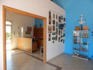 a hallway with a room with blue walls and an open door at Case Vacanze Ancora in Porto Empedocle