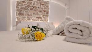 a bouquet of flowers sitting on top of a bed at Mouses Erato in Vathi, Ithaka +28 photos