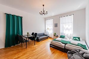 a living room with a bed and a table at My city apartment - Vienna CityRoom in Vienna