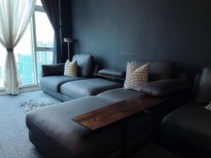 a living room with a couch and a window at Large 2BR Near to Avisena, PKNS,SACC Mall,UitmSek7 Shah Alam in Shah Alam