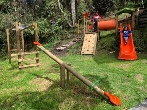 a childrens play area with a playground with a slide at Mirador Bosque Gran Torino Neusa in Cogua