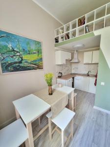 a kitchen and dining room with a table and chairs at Heart of Natural Park, Sea and River in Rīga