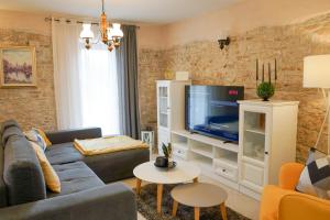 a living room with a couch and a tv at Leon with Private Pool in Sveti Petar u Šumi