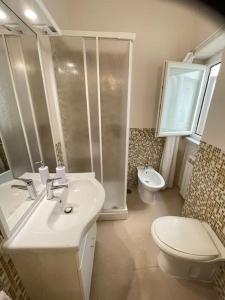a bathroom with a sink and a toilet and a shower at Sunset Ortigia-locazione turistica in Syracuse +5 photos