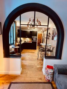 an archway in a living room with a dining room at HUDSON HIGHLANDS Annecy Rent Lodge in Annecy