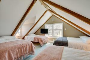 a attic bedroom with two beds and a window at Marlboro Escape 9 Mi to Mount Snow Resort! 