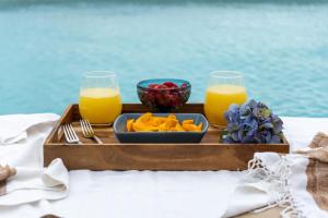 a tray of juice and fruit on a table at 369 "THE BEST APARMENTS NEAR 5TH AV " UrbanTowers in Playa del Carmen