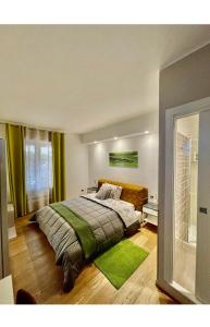a bedroom with a large bed with green accents at Smart House Rooms Luxury in Bergamo