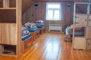 a room with four bunk beds and a wooden floor at Peramaa Puhkekeskus in Meeksi