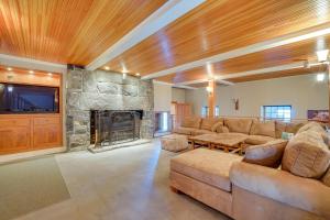 a living room with a couch and a stone fireplace at Peaceful Marlboro Vacation Rental with Sauna and Yard! in Marlboro