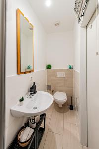 a bathroom with a sink and a toilet at My city apartment- Vienna jungle room in Vienna