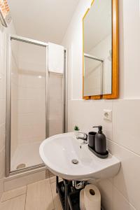 a white bathroom with a sink and a shower at My city apartment- Vienna jungle room in Vienna