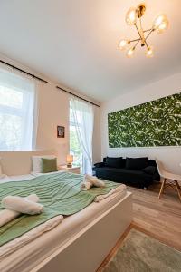 a bedroom with a large bed and a couch at My city apartment- Vienna jungle room in Vienna