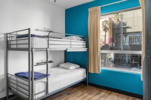 a room with two bunk beds and a window at Samesun Hollywood in Los Angeles