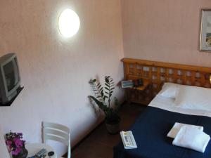 Postel nebo postele na pokoji v ubytování Hotel Scintilla
