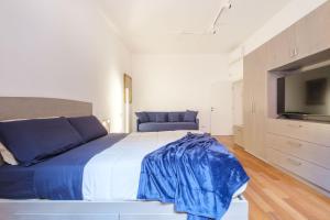 Postel nebo postele na pokoji v ubytování D'Azeglio & Galluzzi Suites