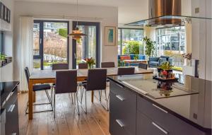 a kitchen and dining room with a table and chairs at Stunning Home In Skien With Jacuzzi, Wifi And 5 Bedrooms in Skien