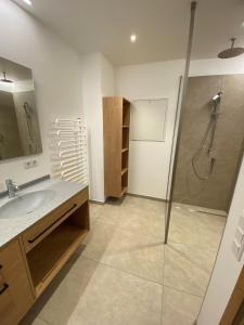 a bathroom with a shower and a sink at Gasthof Schorn in Sankt Leonhard