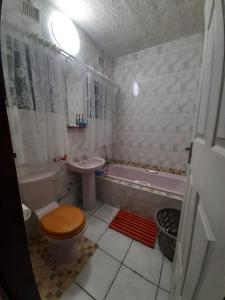 a bathroom with a toilet and a sink and a tub at St Lucia Villa Mia 6 in St Lucia