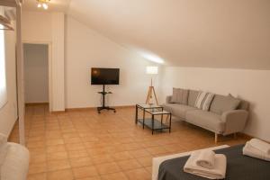 a living room with a couch and a television at Apartamentos Casa Tuli C, ALJARAQUE in Aljaraque