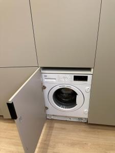 a kitchen with a microwave in a cabinet at Apartamento Sevilla- Los Remedios in Seville