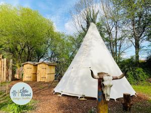 a white teepee with a fire hydrant next to it at Little Wood Lodges Insolites in Bailly-aux-Forges