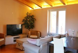 a living room with a couch and a tv at Civico Sei in Menaggio