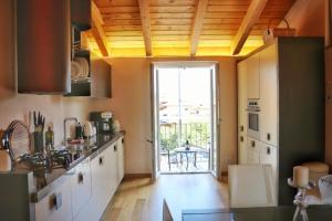 a kitchen with a large door leading to a patio at Civico Sei in Menaggio