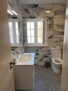 a bathroom with a sink and a toilet at Casa do Mar in Sesimbra +22 photos