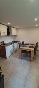 a kitchen and dining room with a wooden table and chairs at Apartament Kopernik in Bystrzyca Kłodzka +9 photos