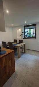 a room with a table and chairs and a window at Apartament Kopernik in Bystrzyca Kłodzka