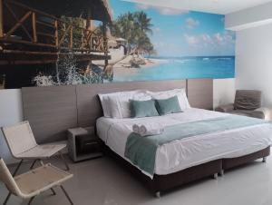 a bedroom with a bed and a painting of a beach at Hotel Santa Clara Boutique in Montería