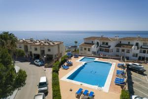 an aerial view of a resort with a swimming pool and the ocean at Pueblo Marina Seaside Apartaments by Alfresco Stays in Mijas Costa