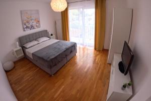 a bedroom with a bed and a flat screen tv at Apartment Flora in Pula