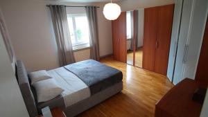 a bedroom with a bed and a large window at Apartment Flora in Pula