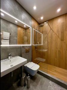 a bathroom with a sink and a toilet and a shower at Hotel Fregat in Kyiv