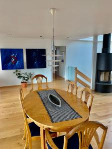a dining room with a wooden table and chairs at Villa top view Tromsø in Tromsø