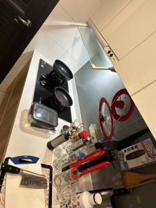 a kitchen counter with a stove top with a bunch of items at MingHOW'S House 清水海線溫馨客房有雙人床位、電視、冷氣、獨立衣櫃 in Erh-t'ang-lang
