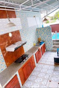 a kitchen with a sink and a stove in it at The Peak Pool villa, Huahin in Hua Hin