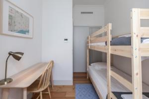 a room with two bunk beds and a desk at FLH Lux Baixa Flat - Historical Center near Tejo River in Lisbon