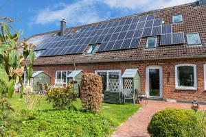 a house with solar panels on the roof at Meerfamilie in Noer