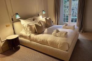 a bedroom with a large bed with two towels on it at Brand new Georgian flat in Bath in Bath +34 photos