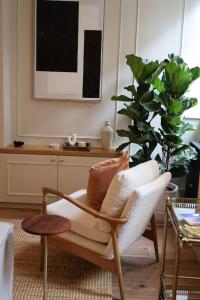 a living room with a chair and a plant at Brand new Georgian flat in Bath in Bath