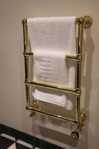 a towel rack in a bathroom with white towels at Brand new Georgian flat in Bath in Bath
