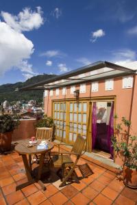 a small house with a table and a patio at Hotel Casa Deco in Bogotá