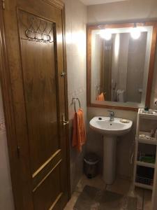 a bathroom with a sink and a wooden door at Casa Karim in Mojácar