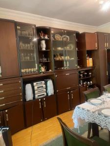 a dining room with brown cabinets and a table at Nelly's Home in Yerevan